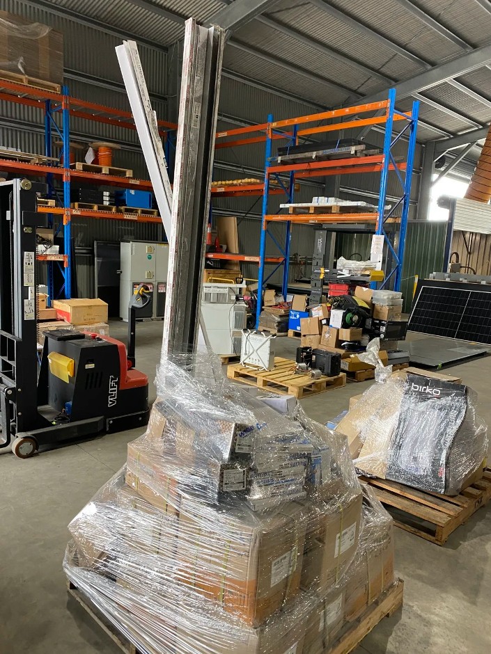 Pallet of Various Solar Panel Roof Mounting System Components and Electrical Components